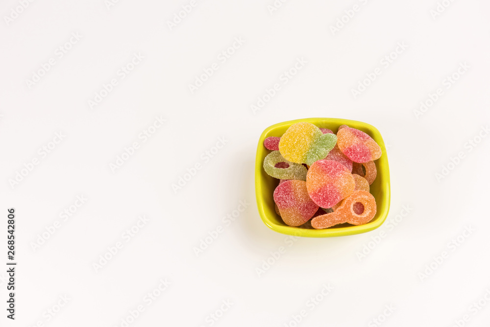 Small bowl with gummy candies isolated on white background. Top view. Small bowl with gummy candies isolated on white background. Top view.