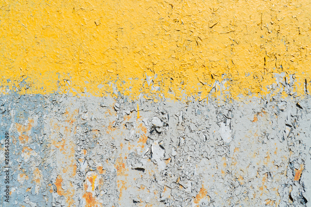 Yellow and gray cracked paint on a metal surface. Yellow and gray cracked paint on a metal surface.