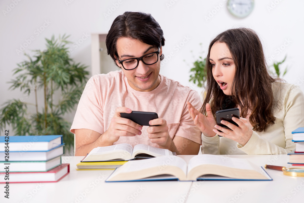 Students preparing for exam together at home Students preparing for exam together at home
