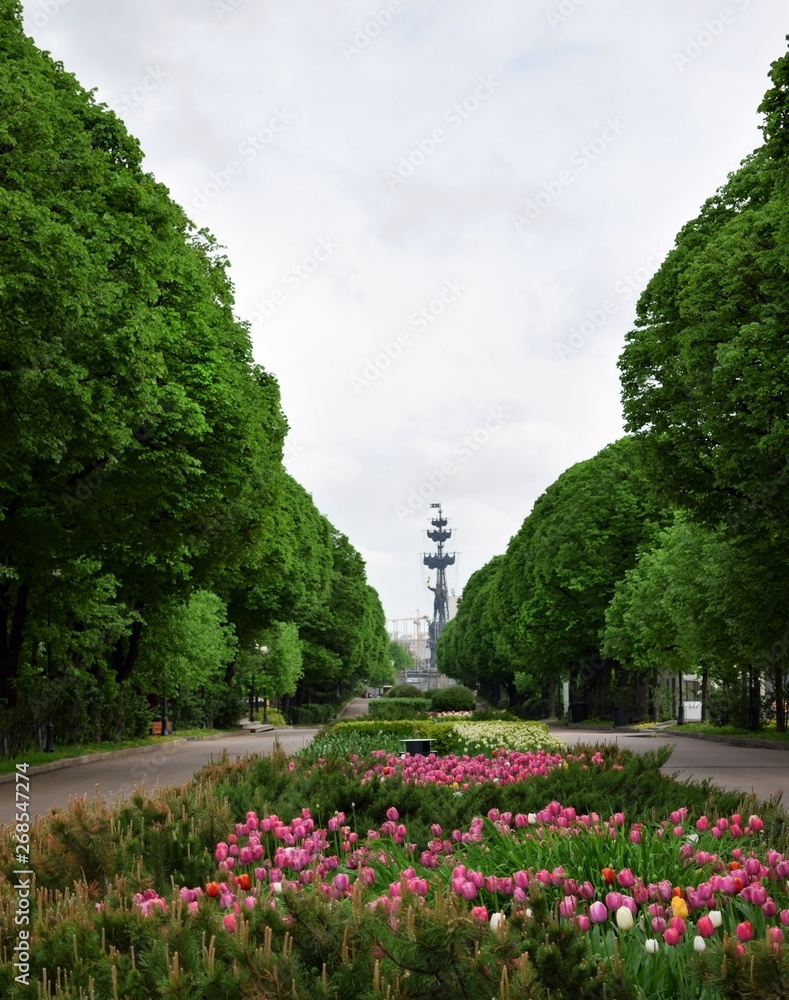 Moscow, Russia - May 13, 2019: Flower beds with tulips in Gorky Park. Monument to Peter the Great in the background Moscow, Russia - May 13, 2019: Flower beds with tulips in Gorky Park. Monument to Peter the Great in the background
