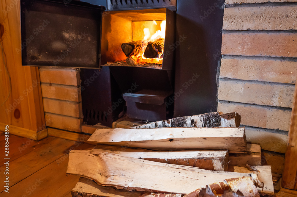 Sauna stove, firewood and fire in the stove. The concept of a bath, sauna,  health care, cleanliness, body treatments. Stock Photo | Adobe Stock