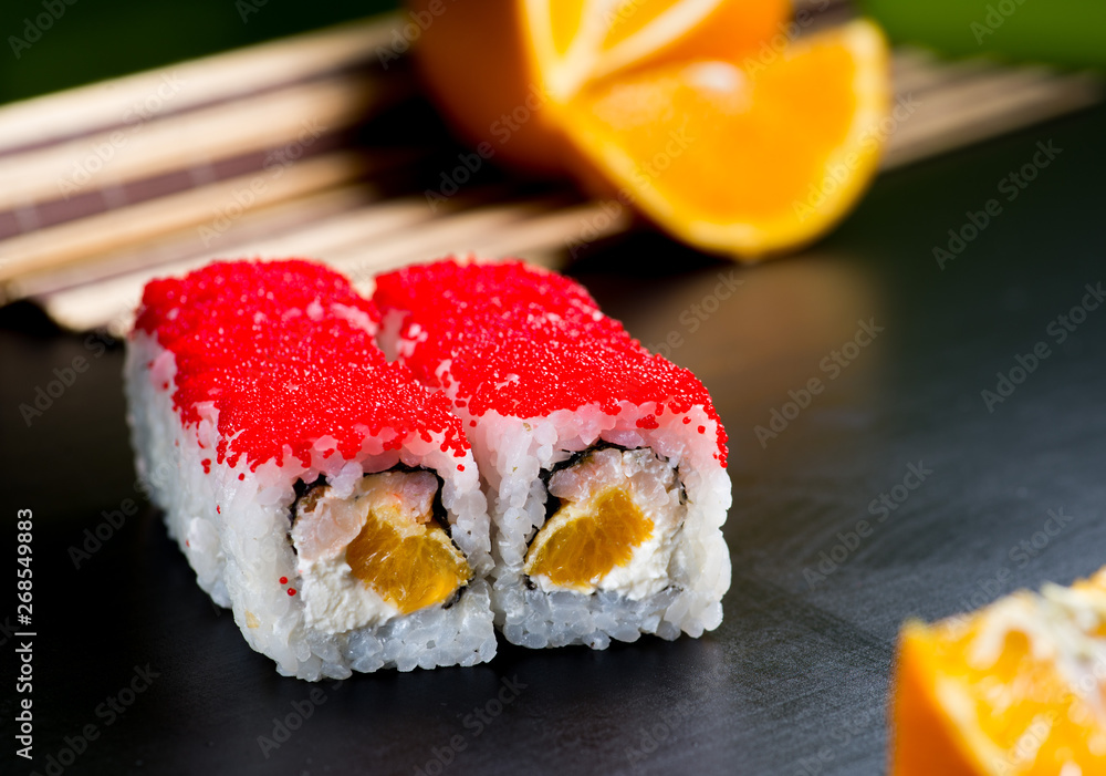 Japanese sushi and rolls on a black background Japanese sushi and rolls on a black background