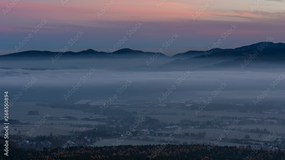 Peaks of hills protruding above the fog in the valley.