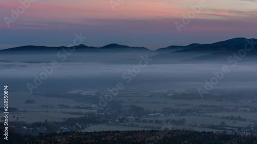 Peaks of hills protruding above the fog in the valley.