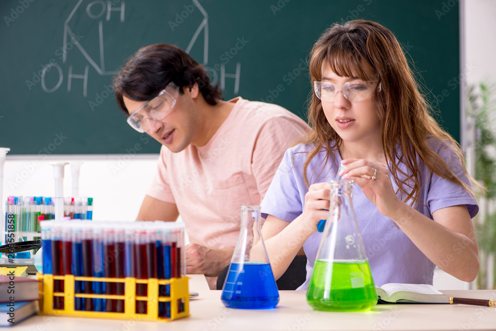 Two chemists students in classroom Two chemists students in classroom