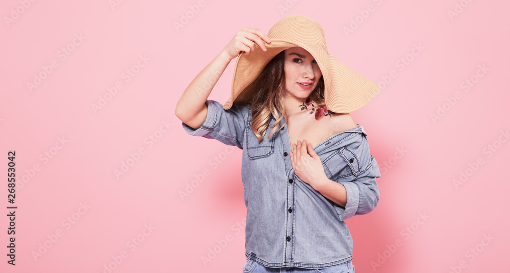 Portrait of a girl in a summer hat on a pink background Portrait of a girl in a summer hat on a pink background
