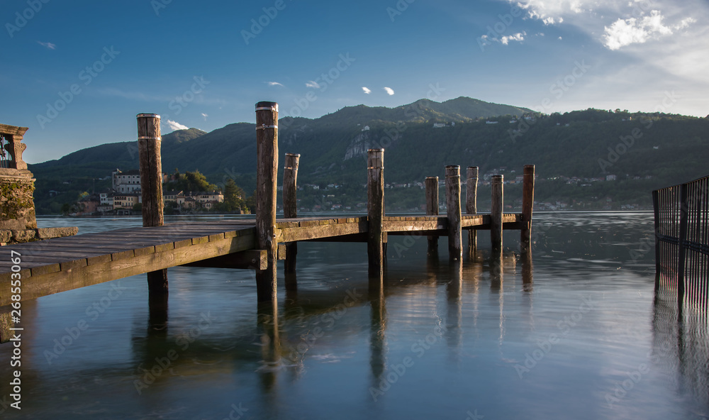 Pier in front of Orta Lake on sunset