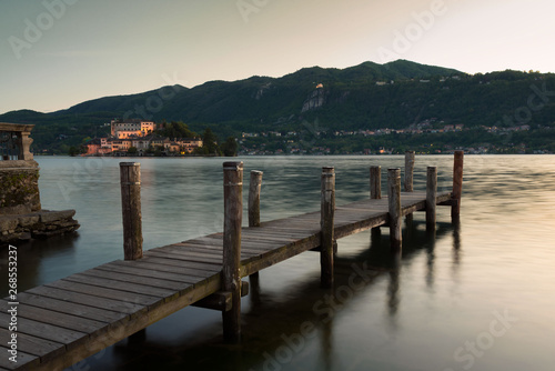 Pier in front of Orta Lake on sunset