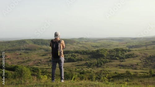 Traveler is viewing the beautiful green valley Apuseni mountains. photo