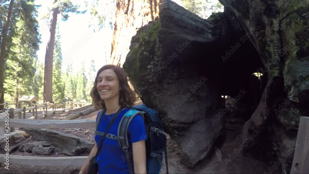 Young woman coming out of Giant Sequoia in Kings Canyon National Park, USA Young woman coming out of Giant Sequoia in Kings Canyon National Park, USA