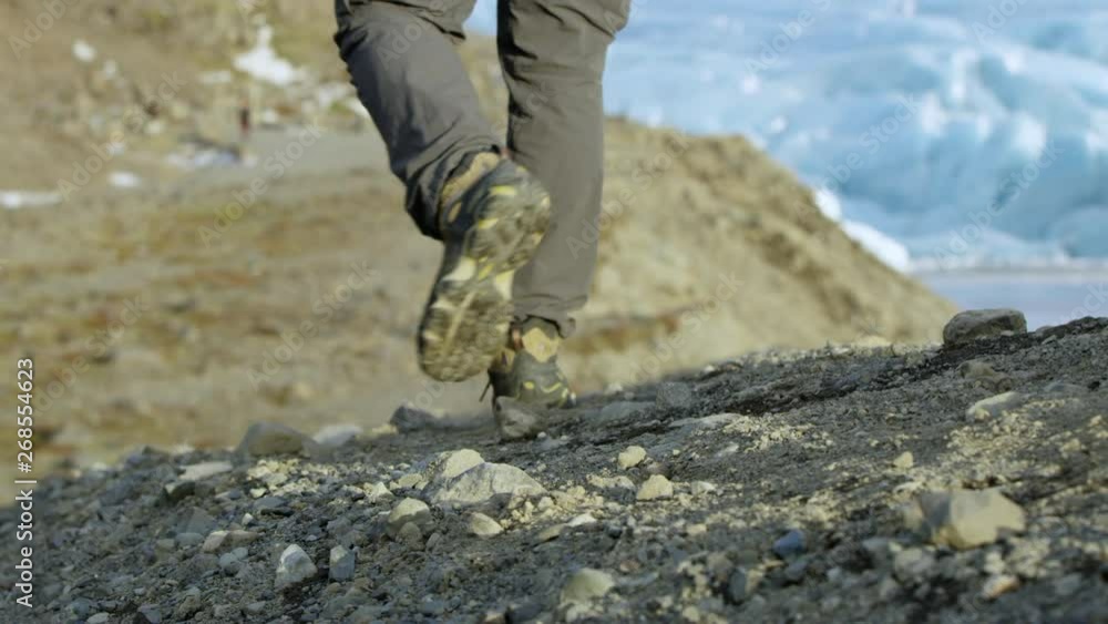 Man Feet Walking Rugged Iceland Glacier Landscape. Man Feet Walking Rugged Iceland Glacier Landscape.