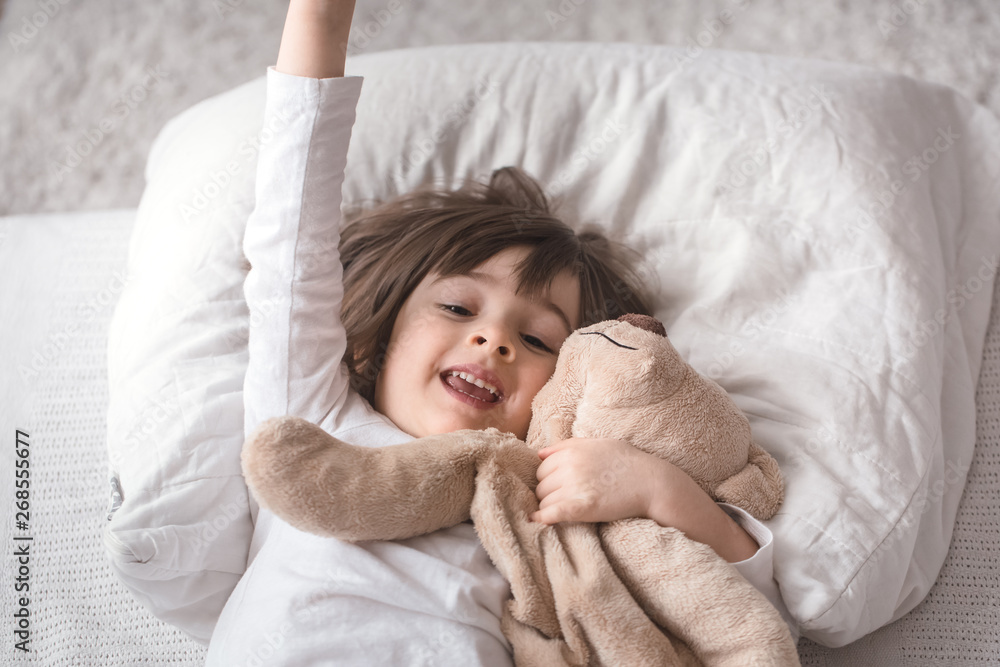 Little cute girl in bed with toy Little cute girl in bed with toy