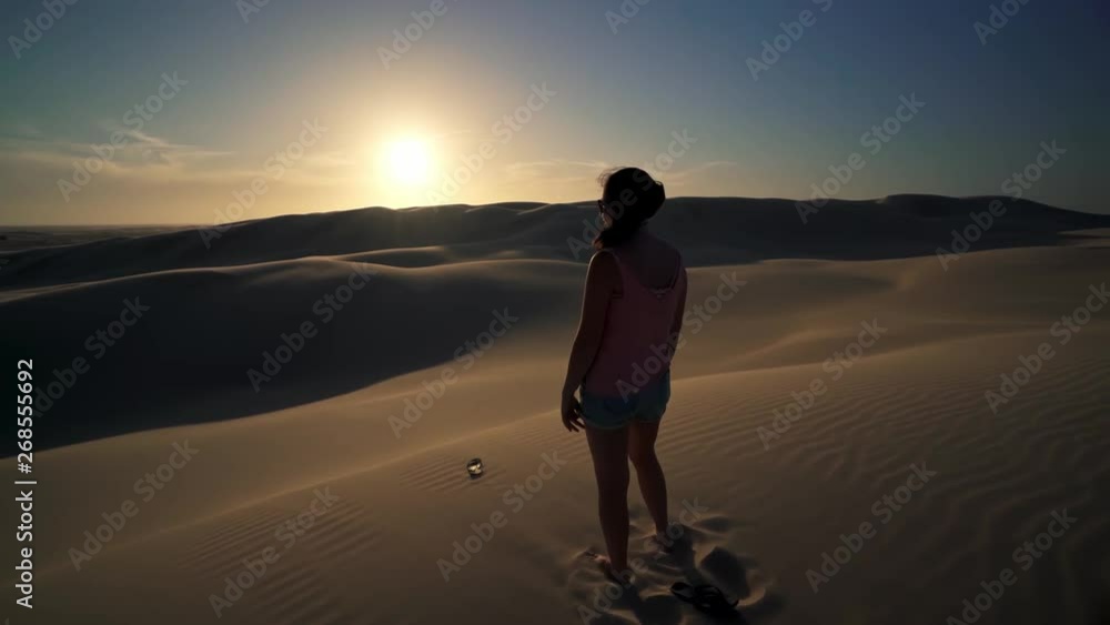 Cinematic Shot of Young Female Standing With Naked Feet on Top of Sand Dune in Desert and Watching Sunset in Stockton Worimi National Park Australia 4k Cinematic Shot of Young Female Standing With Naked Feet on Top of Sand Dune in Desert and Watching Sunset in Stockton Worimi National Park Australia 4k