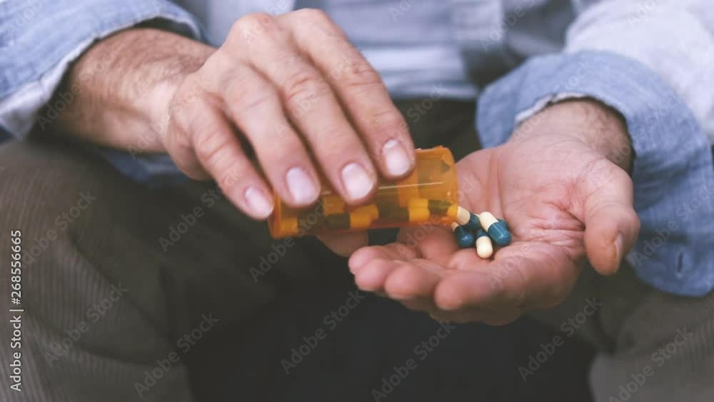 Old man taking a pill Old man taking a pill