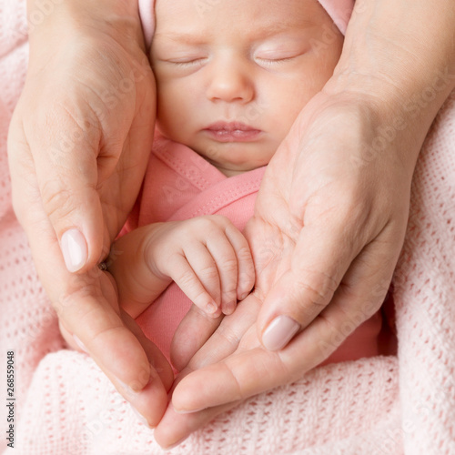 Newborn Baby Portrait in Family Hands, Sleeping New Born Kid, Parents Care and Love Concept