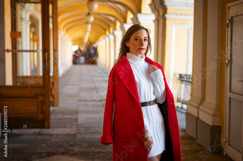 fashion woman in red jacket standing in the street