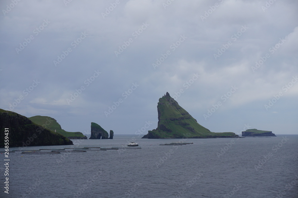 Faeroe Islands with beautiful nature, green grasslands, sea, rocks and breathtaking landscape