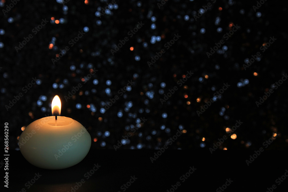 Candles Burning at Night. White Candles Burning in the Dark with focus on single candle in foreground. Candles Burning at Night. White Candles Burning in the Dark with focus on single candle in foreground.