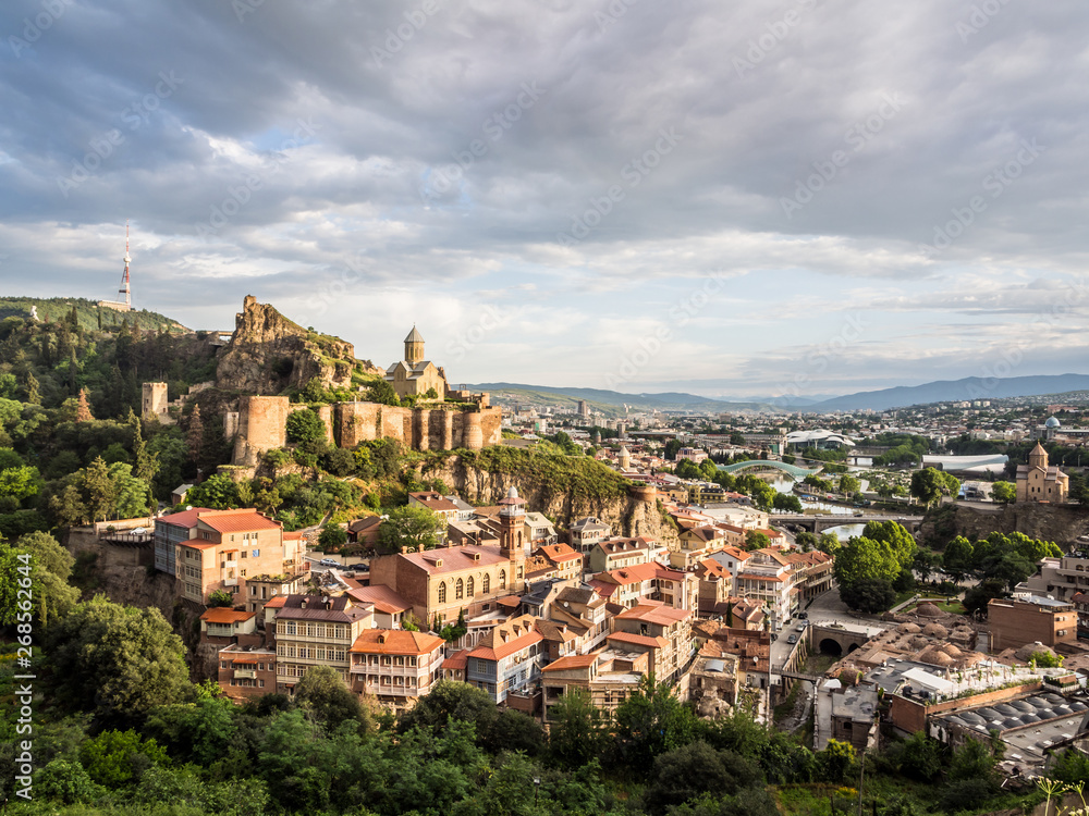 Horizontal photo of the Narikala fortress and the surrounding architecture of the Old Town in Tbilisi, Georgia, Caucasus, taken on early morning. Wide angle.