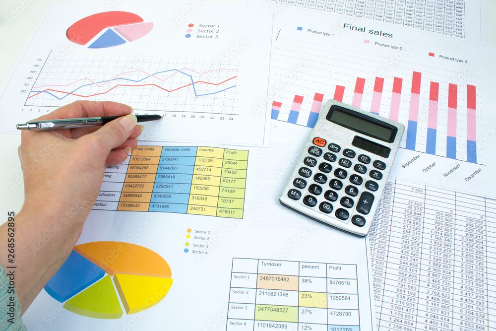 Financial printed paper charts, graphs and diagrams on the table. Top view Financial printed paper charts, graphs and diagrams on the table. Top view