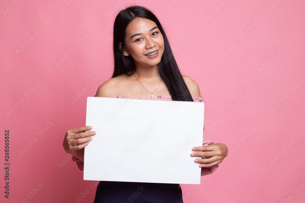 Young Asian woman with white blank sign. Young Asian woman with white blank sign.