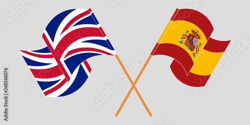Crossed and waving flags of the UK and Spain