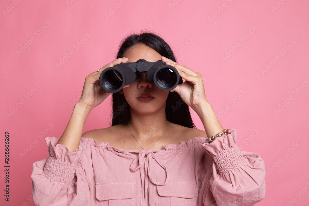 Young Asian woman with binoculars. Young Asian woman with binoculars.