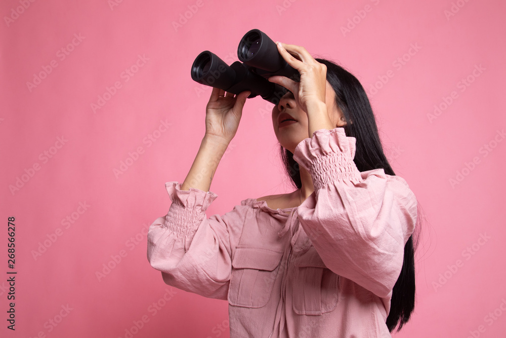 Young Asian woman with binoculars. Young Asian woman with binoculars.