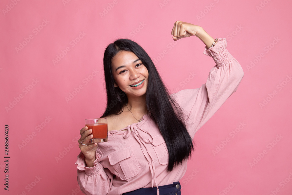Strong healthy Asian woman with tomato juice. Strong healthy Asian woman with tomato juice.