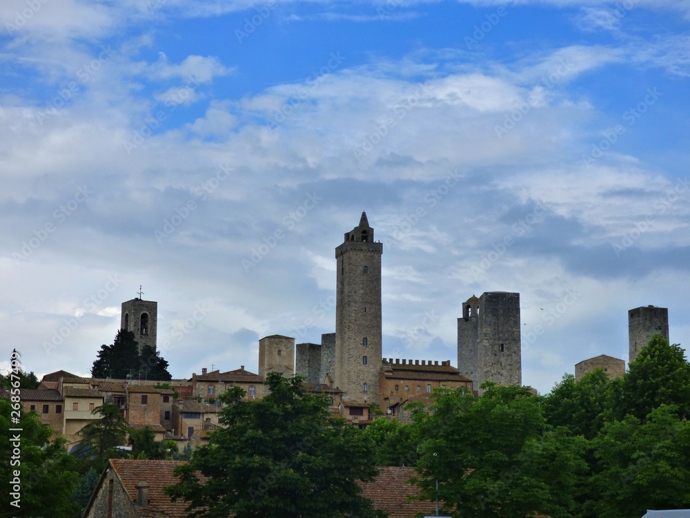 Skyline View of the Towers of San Gimignano with a blue sky and white cloud background Skyline View of the Towers of San Gimignano with a blue sky and white cloud background