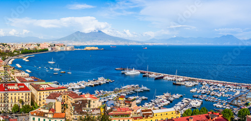 Naples city and port with Mount Vesuvius on the horizon seen from the hills of Posilipo. SSeaside landscape of the city harbor and golf on the Tyrrhenian Sea photo