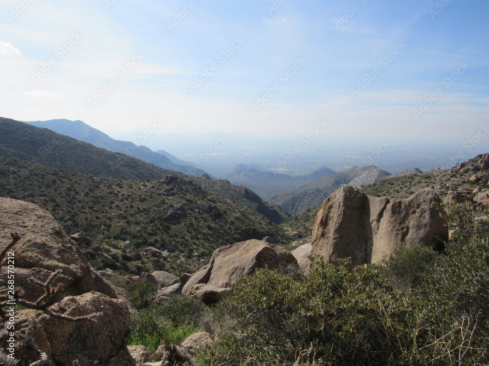 View from Tom's Thumb in the McDowell Mountain range in the Sonoran desert near Scottsdale, Arizona, with a rocky landscape and blue sky 