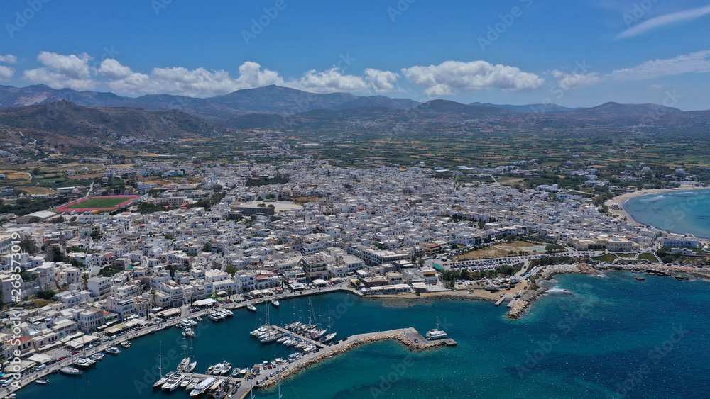 Aerial drone photo of iconic port of Naxos island featuring uphill castle and beautiful Temple of Apollon or Gate, Cyclades, Greece Aerial drone photo of iconic port of Naxos island featuring uphill castle and beautiful Temple of Apollon or Gate, Cyclades, Greece