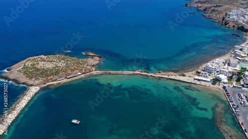 Aerial drone panoramic view of iconic and unique Temple of Apollon or Portara (Gate) with breathtaking views to port - town and castle of Naxos island and the Aegean blue sea, Cyclades, Greece