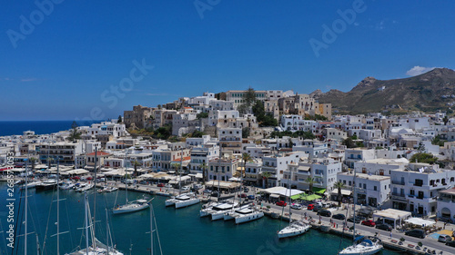 Aerial drone photo of iconic port of Naxos island featuring uphill castle and beautiful Temple of Apollon or Gate, Cyclades, Greece © aerial-drone