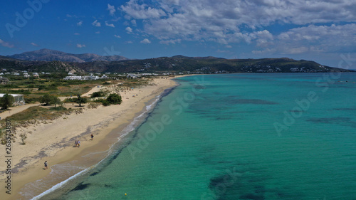 Aerial drone top view photo of breathtaking turquoise sandy beach of Plaka with sun beds and umbrellas, Naxos island, Cyclades, Greece