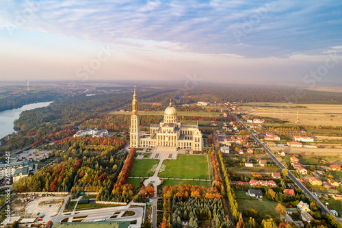 Sanctuary and Basilica of Our Lady of Licheń in small village Lichen. The biggest church in Poland, one of the largest in the World. Famous Catholic pilgrimage site. Aerial view in fall. Sunset light