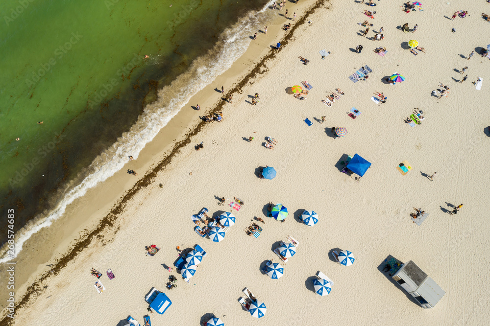 Aerial overhead shot of people under umbrellas on the beach Aerial overhead shot of people under umbrellas on the beach