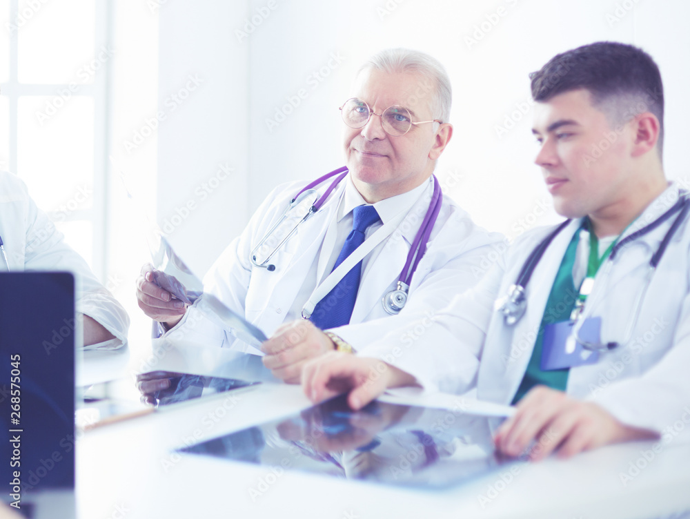 Medical team sitting and discussing at table Medical team sitting and discussing at table