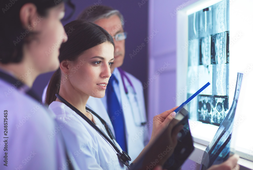 Hospital doctors looking at x-rays in an emergency room Hospital doctors looking at x-rays in an emergency room
