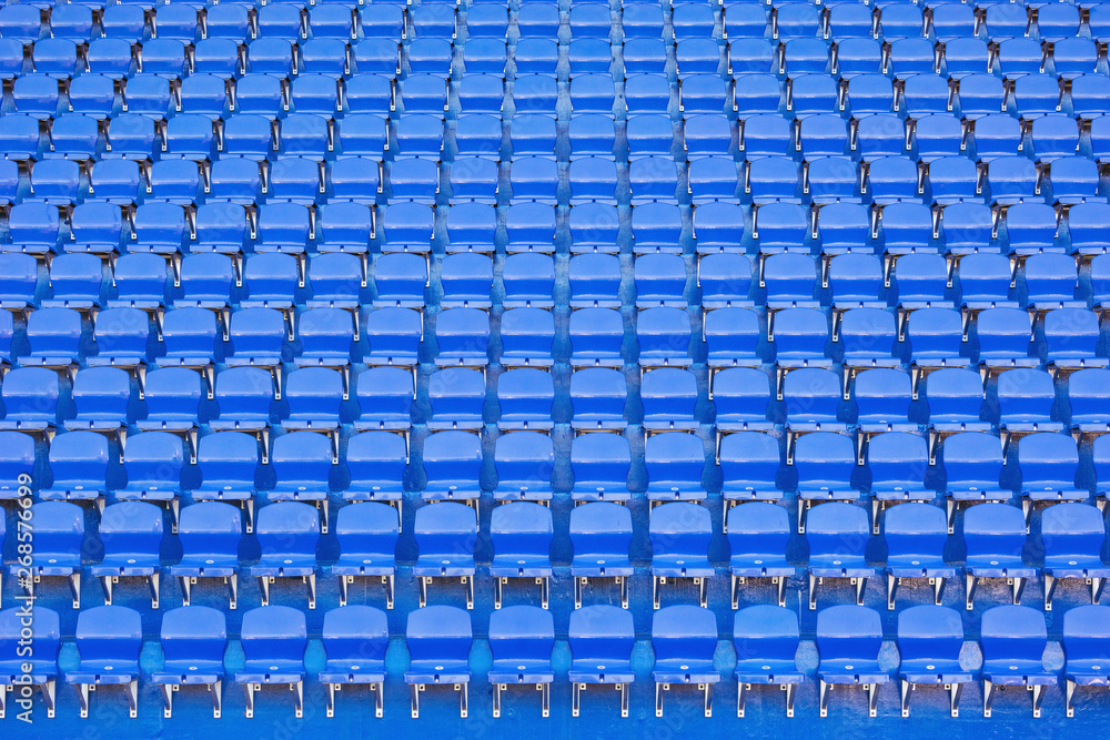 Fototapeta premium Blue empty seats on the tribune of the new stadium.