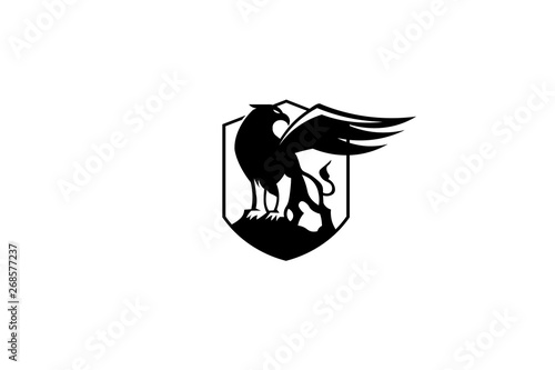  the black griffin looks back. spread wings isolated logo in vector