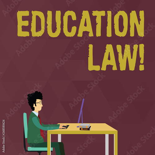 Writing note showing Education Law. Business concept for legal discipline covering all issues pertaining to schools Businessman Sitting on Chair Working on Computer and Books
