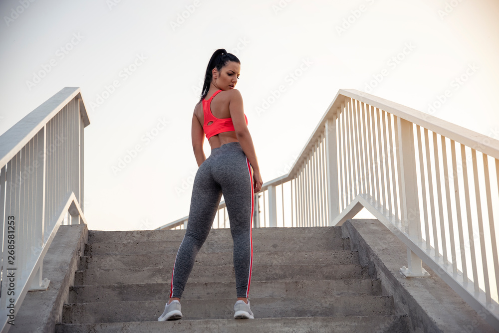 Young woman amazing body standing on steps , runner concept 