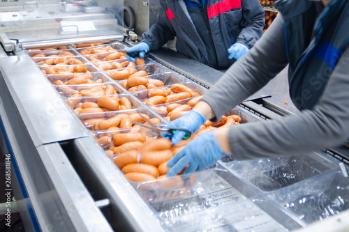 Sausages. Packing line of sausage. Industrial manufacture of sausage products.