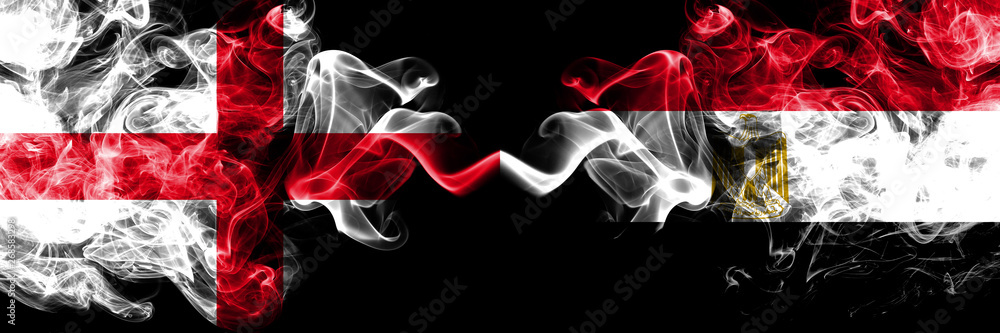 Fototapeta premium English vs Egypt, Egyptian smoky mystic flags placed side by side. Thick colored silky smokes flag of England and Egypt, Egyptian.