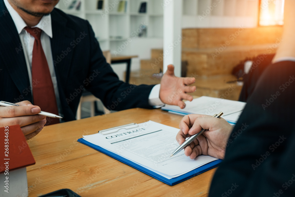Real estate agents submit documents for customers to sign for a sale contract,real estate concept. Real estate agents submit documents for customers to sign for a sale contract,real estate concept.