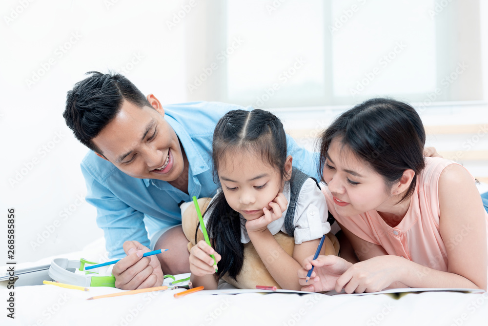 Asian people, Happy family in bedroom at home. Mother, Father and the children playing, Activities of family members are good family health of three people Education of kids, Health Insurance concept. Asian people, Happy family in bedroom at home. Mother, Father and the children playing, Activities of family members are good family health of three people Education of kids, Health Insurance concept.