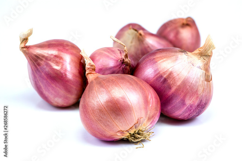 Pile of red shallots onion isolated on white background . Condiment concept.
