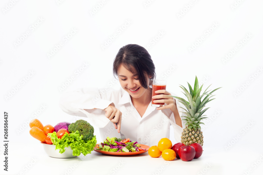 Asian young woman is happy with Vegetable salad with Tomato juice and fruit. Healthy eating , Fresh food, Clean eating recipes to fuel body from the inside out concept. Asian young woman is happy with Vegetable salad with Tomato juice and fruit. Healthy eating , Fresh food, Clean eating recipes to fuel body from the inside out concept.